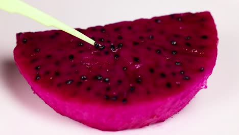 extracting seeds from a dragon fruit slice