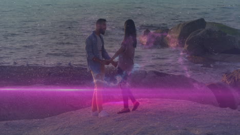 couple holding hands on beach with glowing pink and blue animation overlay