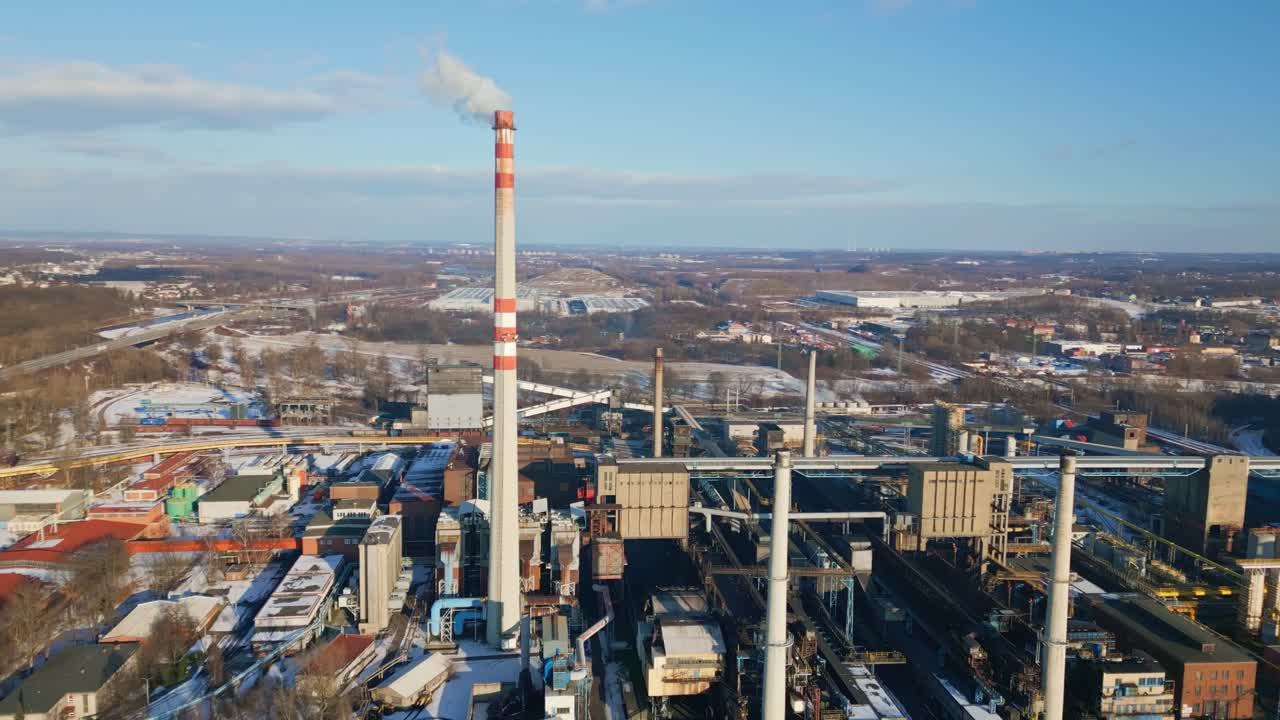 Smoke stacks pollute winter sky from industrial coking plant Ostrava AERIAL