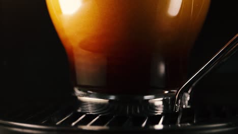 extreme close up of pouring hot coffee into a glass cup. lockdown