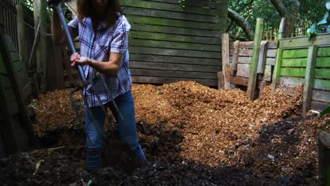 mujer madura usando tenedor de jardinería en el jardín 4k