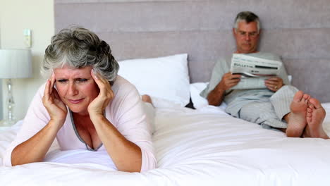 woman with headache rubbing her temples