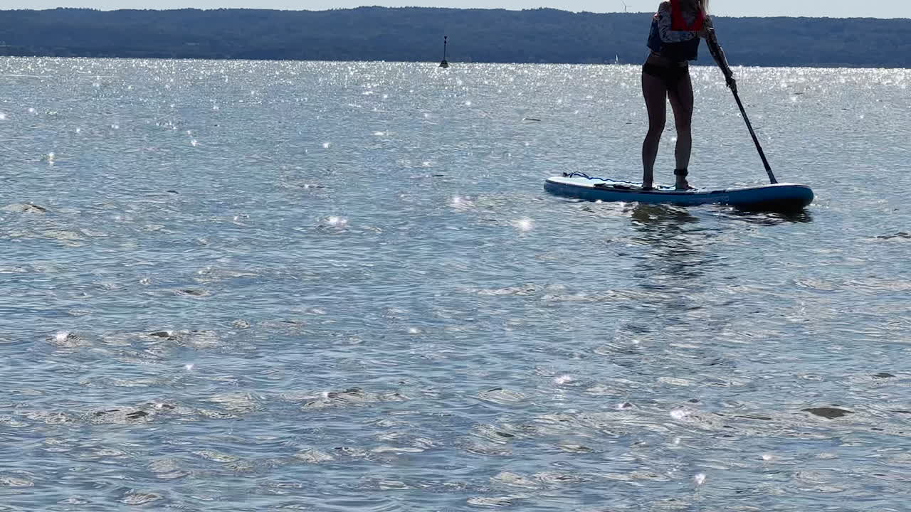 A girl swimming on a SUP