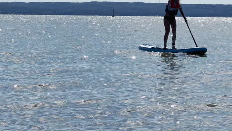 a girl swimming on a sup