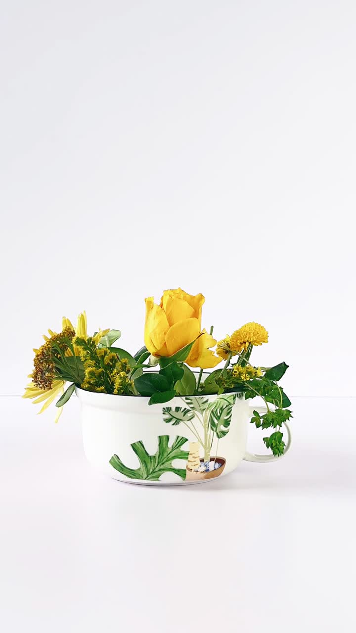 Yellow Flower Arrangement in a Decorative Cup