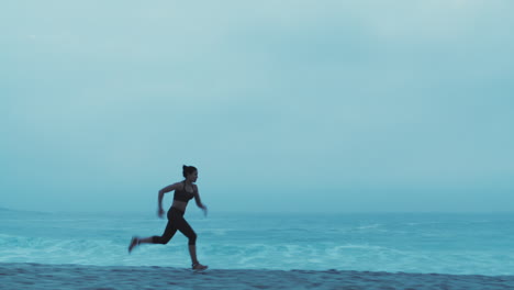 Fitness,-sunset-and-woman-running-on-beach