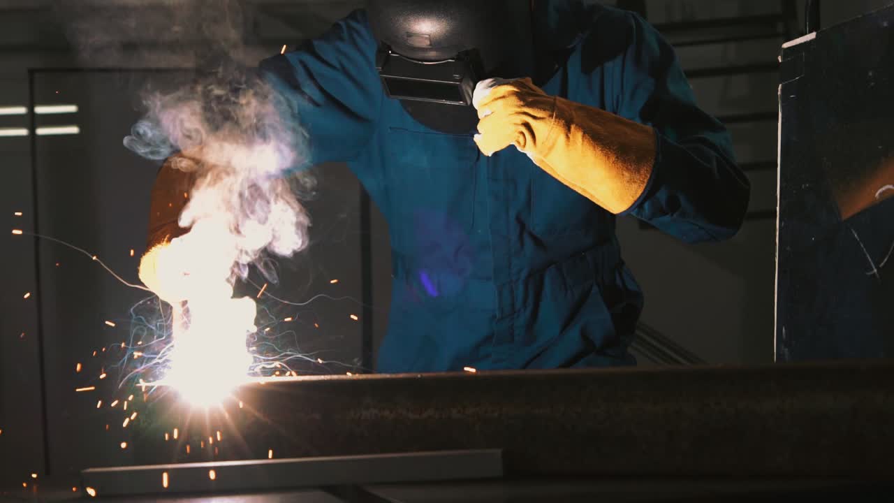 Metal welder working with arc welding machine