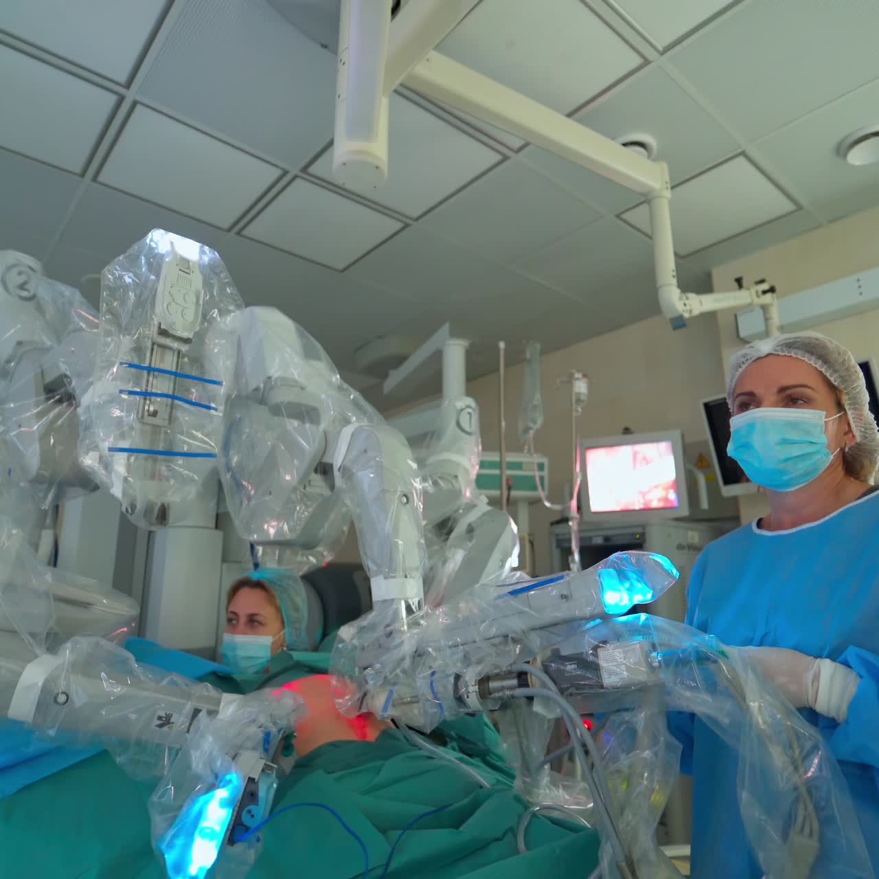 Modern medical equipment with robotic arms. Minimally invasive robotic surgery in clinic. Operating room with modern medicine. Doctors control the work of medical robot