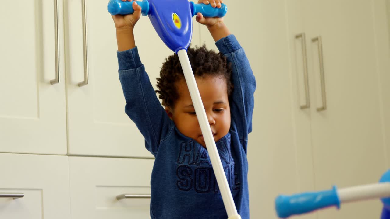 Front view of cute little black kid playing in a comfortable home 4k