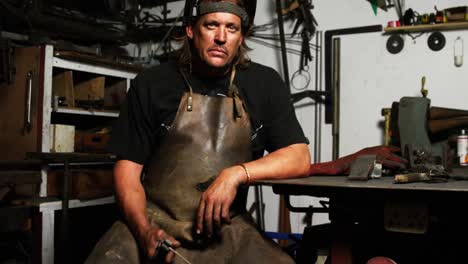 portrait of welder sitting with welding arch