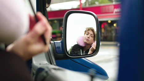 woman making up herself in a van