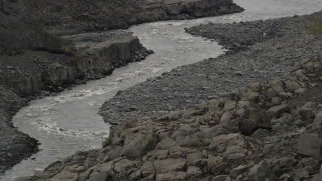 tight frame tilt up reveal along the harsh and barren jokulsa a fjollum river below dettifoss waterfalls iceland