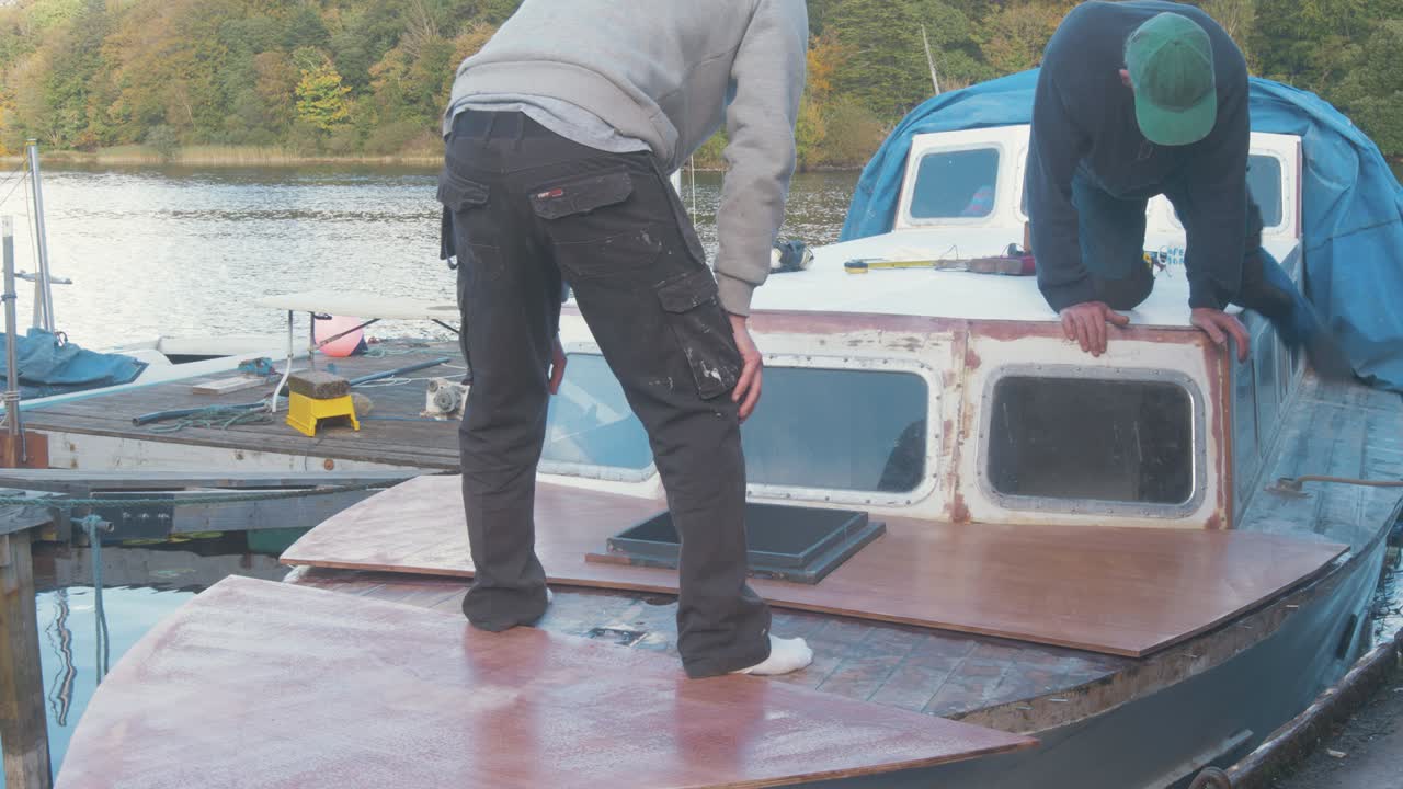 Carpenters glue plywood over wood boat foredeck