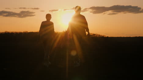 couple walking towards sunset