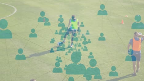 Animation-of-network-of-connections-with-people-icons-over-football-players-practicing