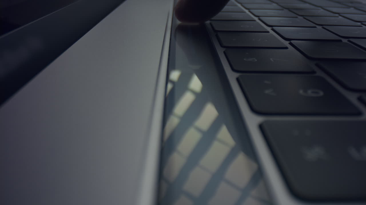 Man hand using touch bar on laptop. Male fingers pushing touch buttons on laptop