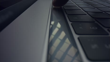 Man-hand-using-touch-bar-on-laptop.-Male-fingers-pushing-touch-buttons-on-laptop