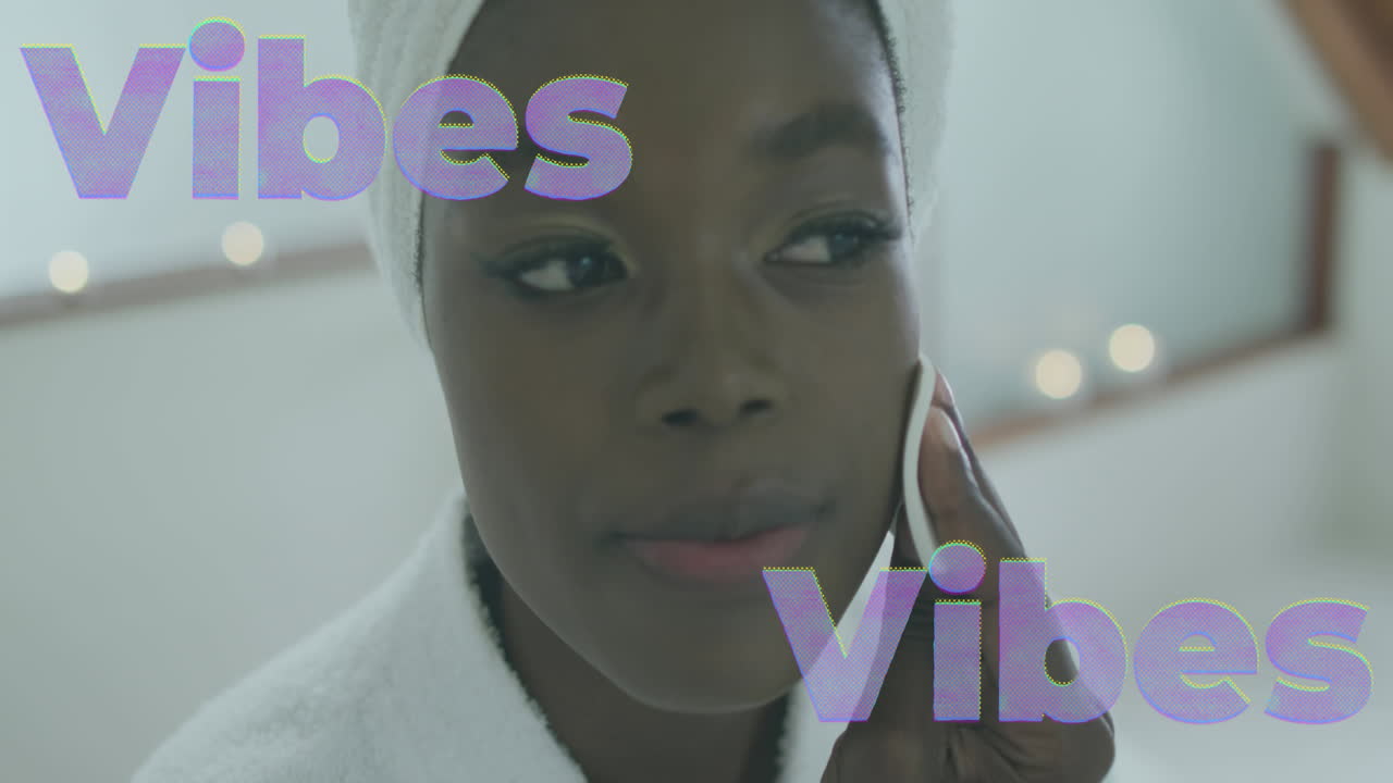 Animation of vibes text in lilac over happy african american woman cleansing face at home