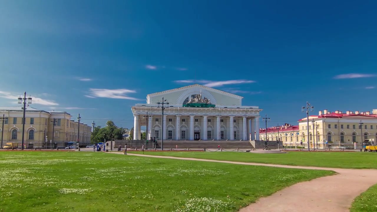 Ilha Vasilievsky. Vista da antiga bolsa de valores e do Museu Naval timelapse hyperlapse. Canteiro de flores vermelho e gramado verde. São Petersburgo. Rússia.