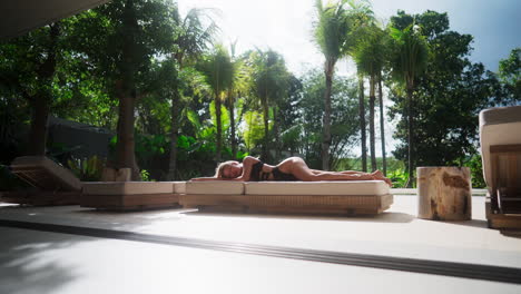 woman relaxing by the pool in a tropical paradise
