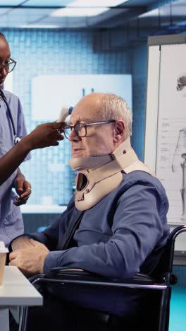 elderly patient receiving medical care in a wheelchair with a neck brace