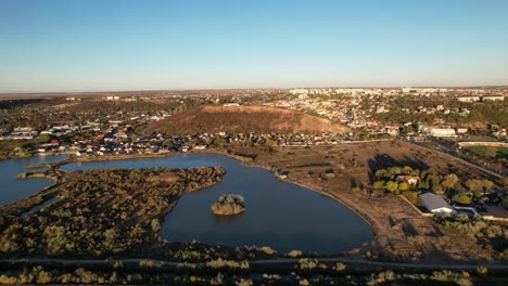 Drone-flying-towards-hill-at-the-outer-limits-of-a-city