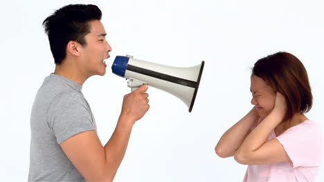 Asian-man-shouting-on-megaphone-to-his-girlfriend