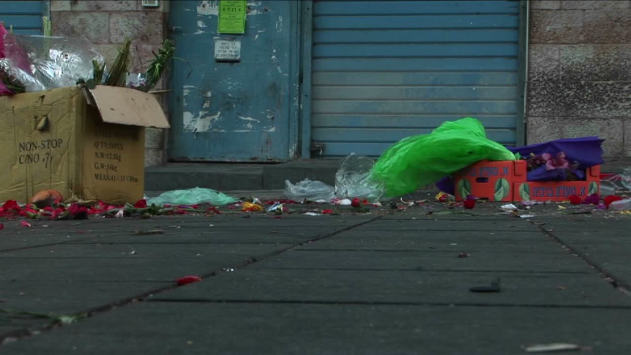 Trash and garbage line an urban city street