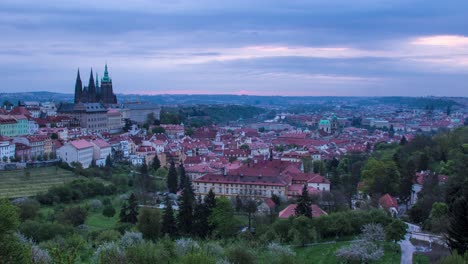 Sonnenaufgang-Von-Nacht-Zu-Tag-In-Prag,-Tschechische-Republik,-Von-Den-Strahov-Gärten-Aus-Gesehen,-Mit-Blick-Auf-Die-Prager-Burg,-Malá-Strana-Und-Die-Innenstadt-In-Der-Ferne,-Während-Die-Morgensonne-Die-Stadt-Erleuchtet