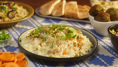 eating couscous with chicken on table close-up. arabian cuisine. pita and bulgur on background. traditional middle eastern culture. delicious rice with meat. homemade food concept