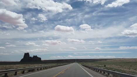 driving down a remote arizona highway on a summer day