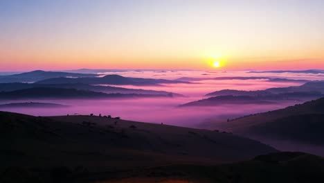 rising sun illuminates foggy hills, creating a stunning landscape filled with natural beauty and tranquil morning light