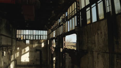 Sun-shining-through-windows-inside-old-rundown-abandoned-factory