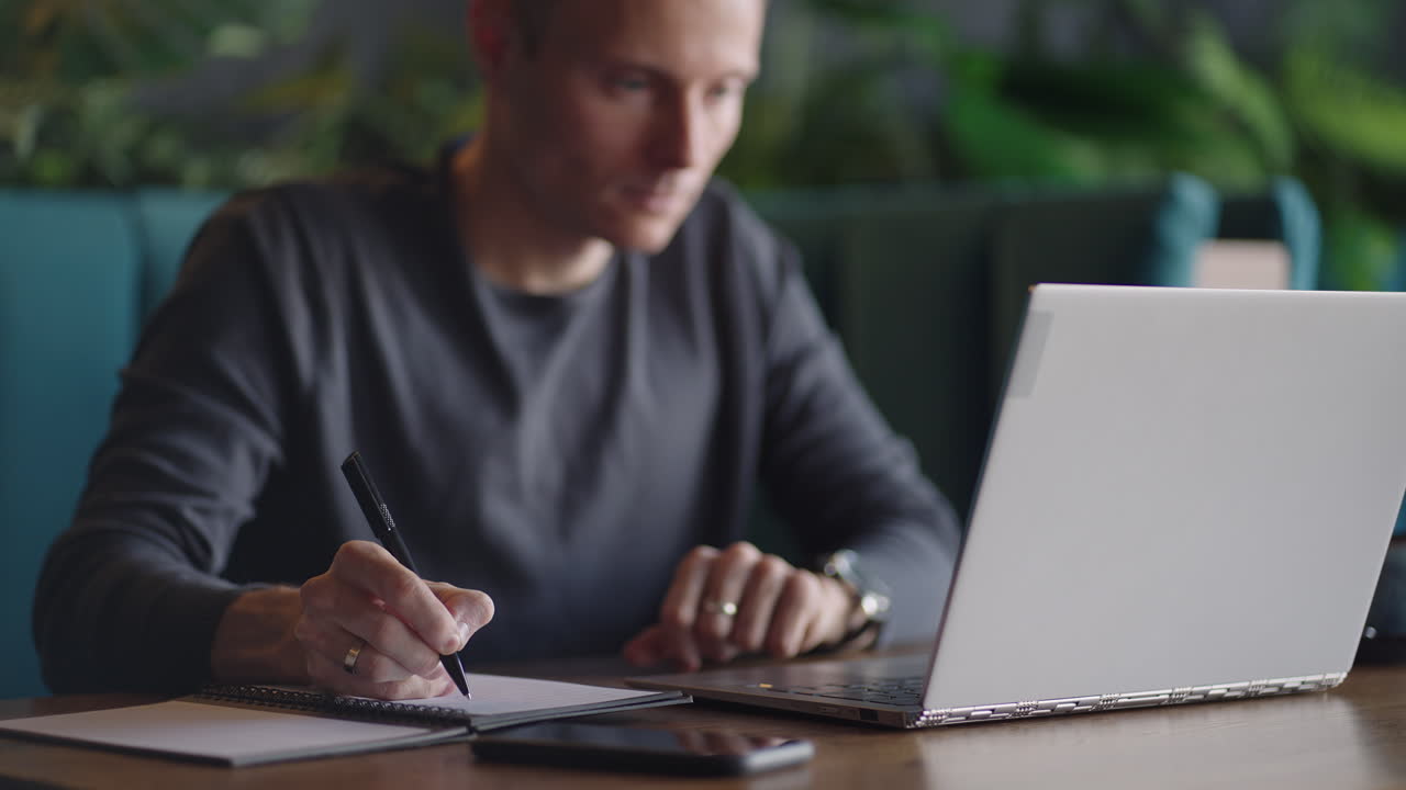 Hispanic latin man college student using laptop computer watching distance online learning seminar class remote university webinar or having virtual classroom meeting in university creative space.