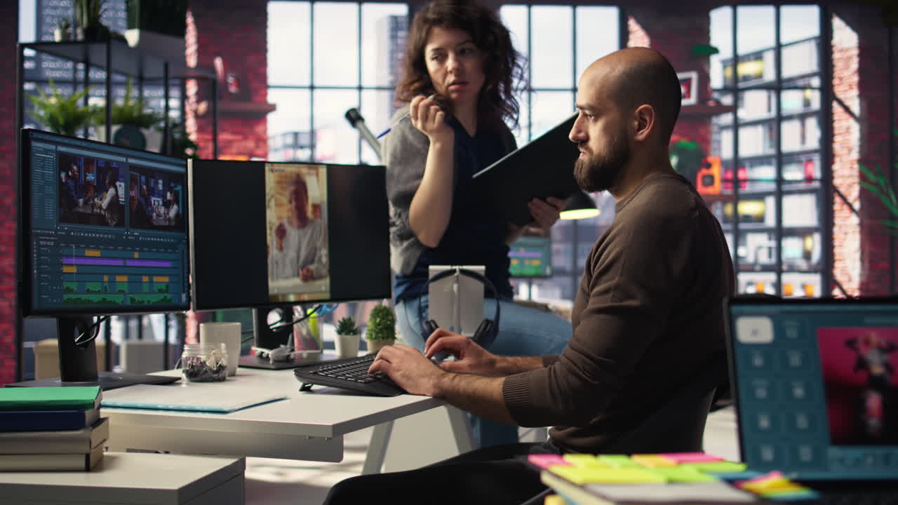 Team edits smartphone video footage on a dual monitors setup