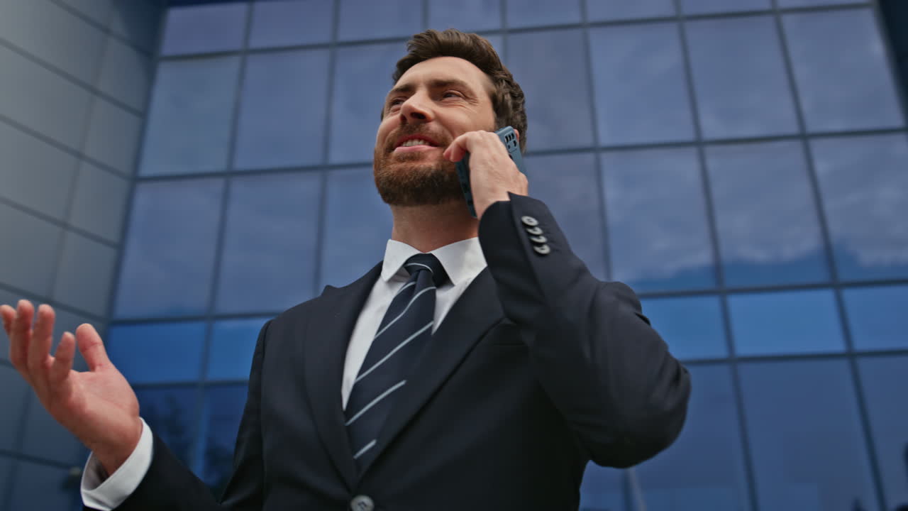 Successful business owner calling cellphone in city street closeup. Businessman