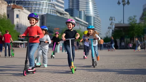 children riding scooters and having fun in a city plaza