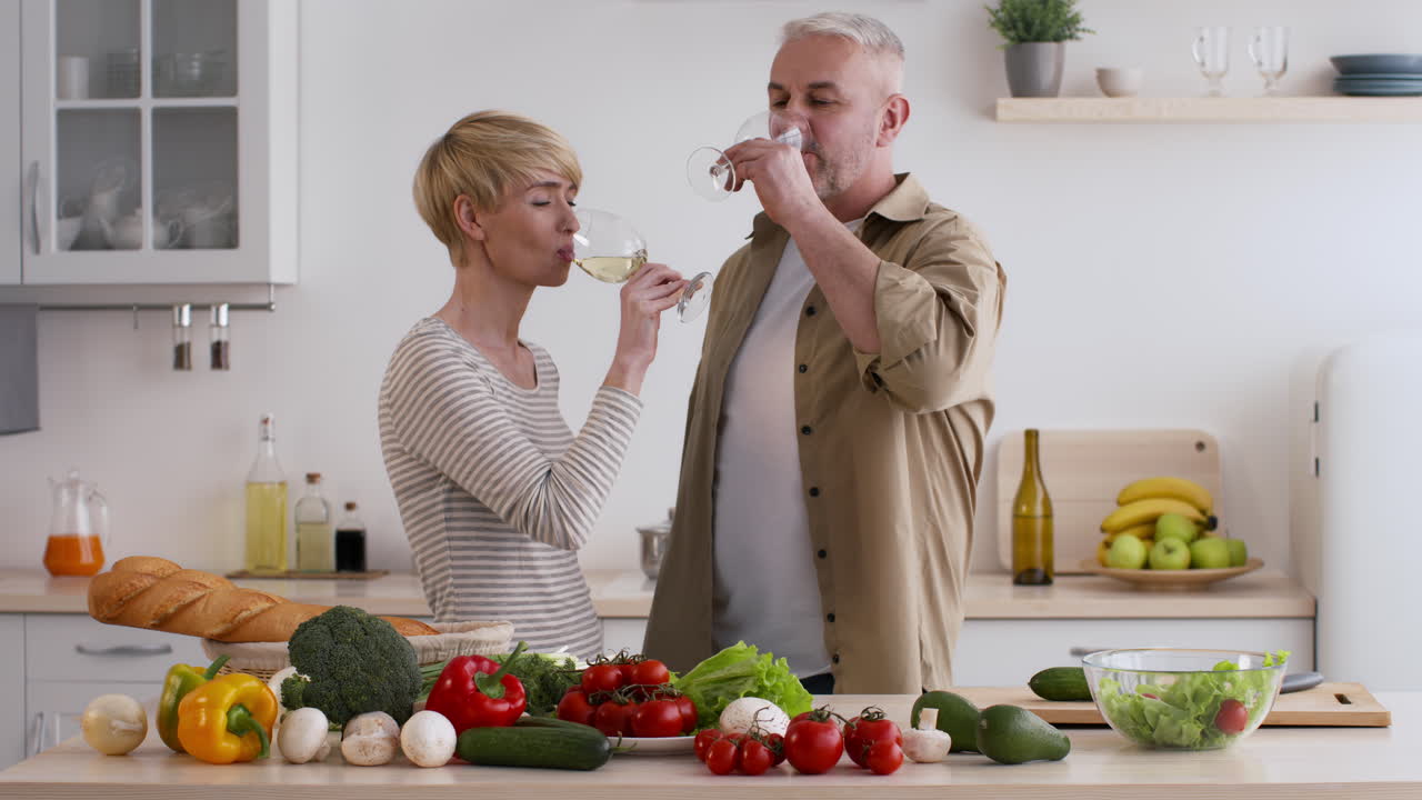 Couple toasting with wine in a kitchen