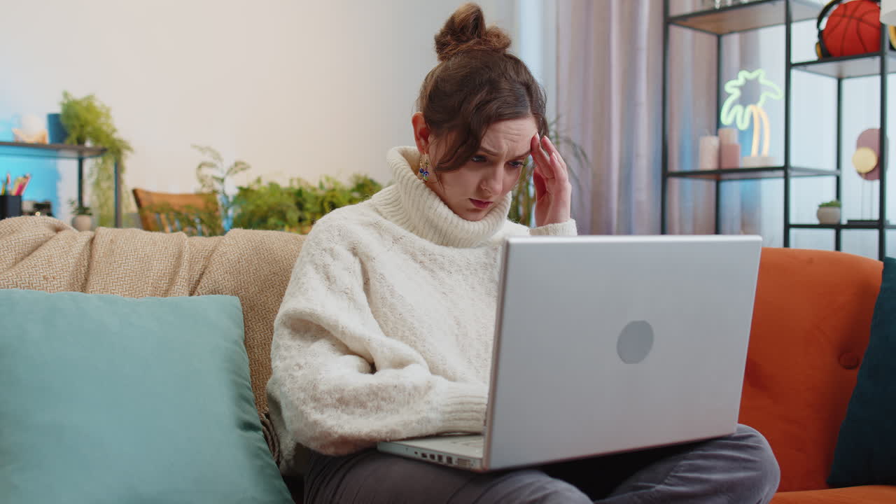 Tired young woman freelancer use laptop suffering from headache problem tension and migraine stress