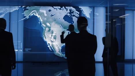 businessmen discussing strategy using a world map