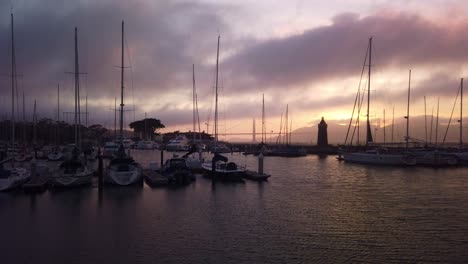 gimbal panning shot across boat marina with the golden gate bridge in the background at magic hour in san francisco, california