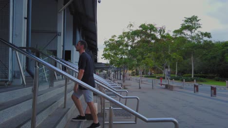 A-Lone-Man-Walking-Up-The-Steps-cairns-With-Green-Trees-on-The-Background