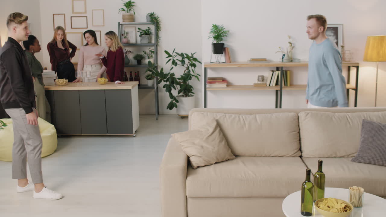 Man Greeting Friend at Get-Together in Cozy Apartment