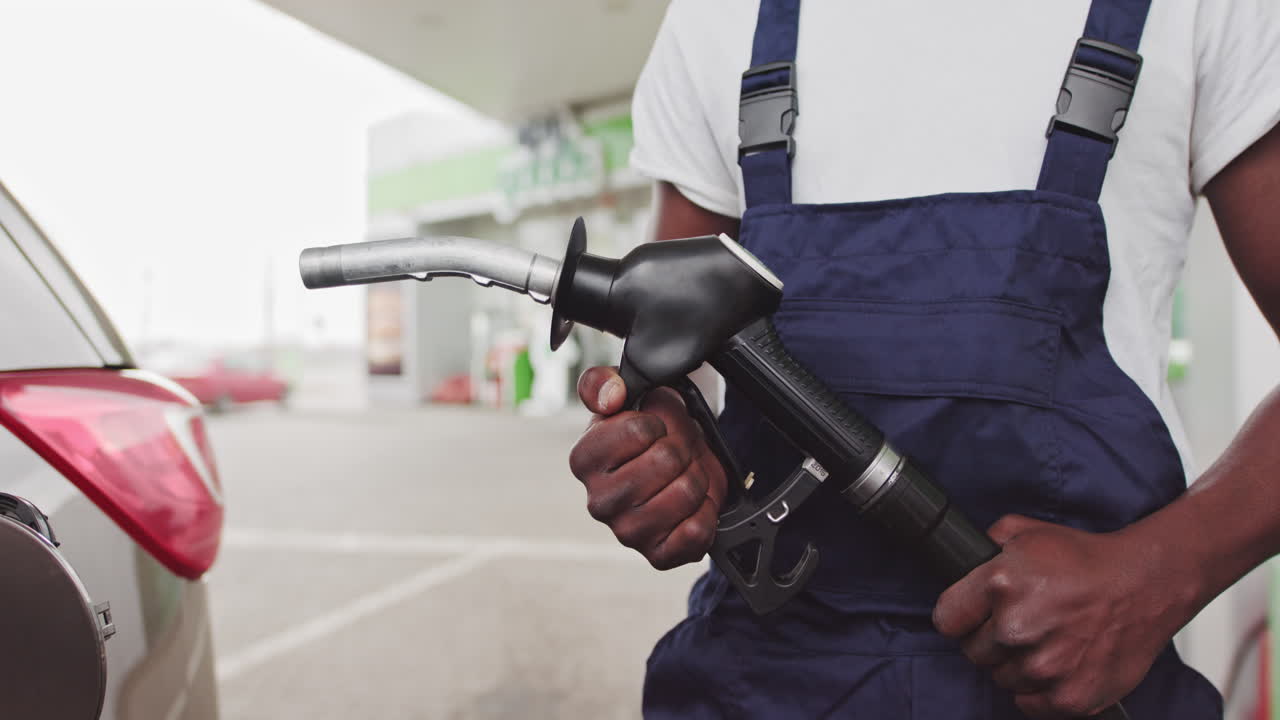 Person filling gas in a car at a gas station