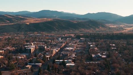 static drone shot viewing downtown bozeman, montana at sunrise in the fall