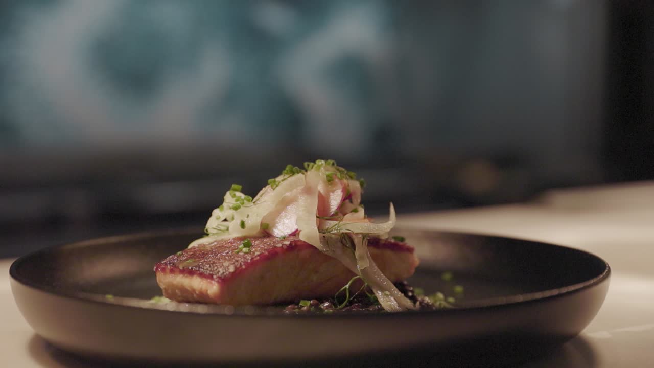 Freshly prepared salmon elegantly plated on a tabletop