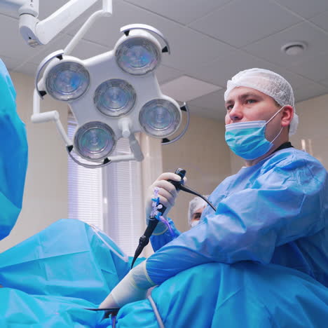 surgery process. professional doctor with nurse perform endoscopic operation to a patient. operating room in modern clinic.