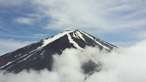 timelapse aerial view from the top of mount fuji with fast moving clouds and an opening clouds like curtain