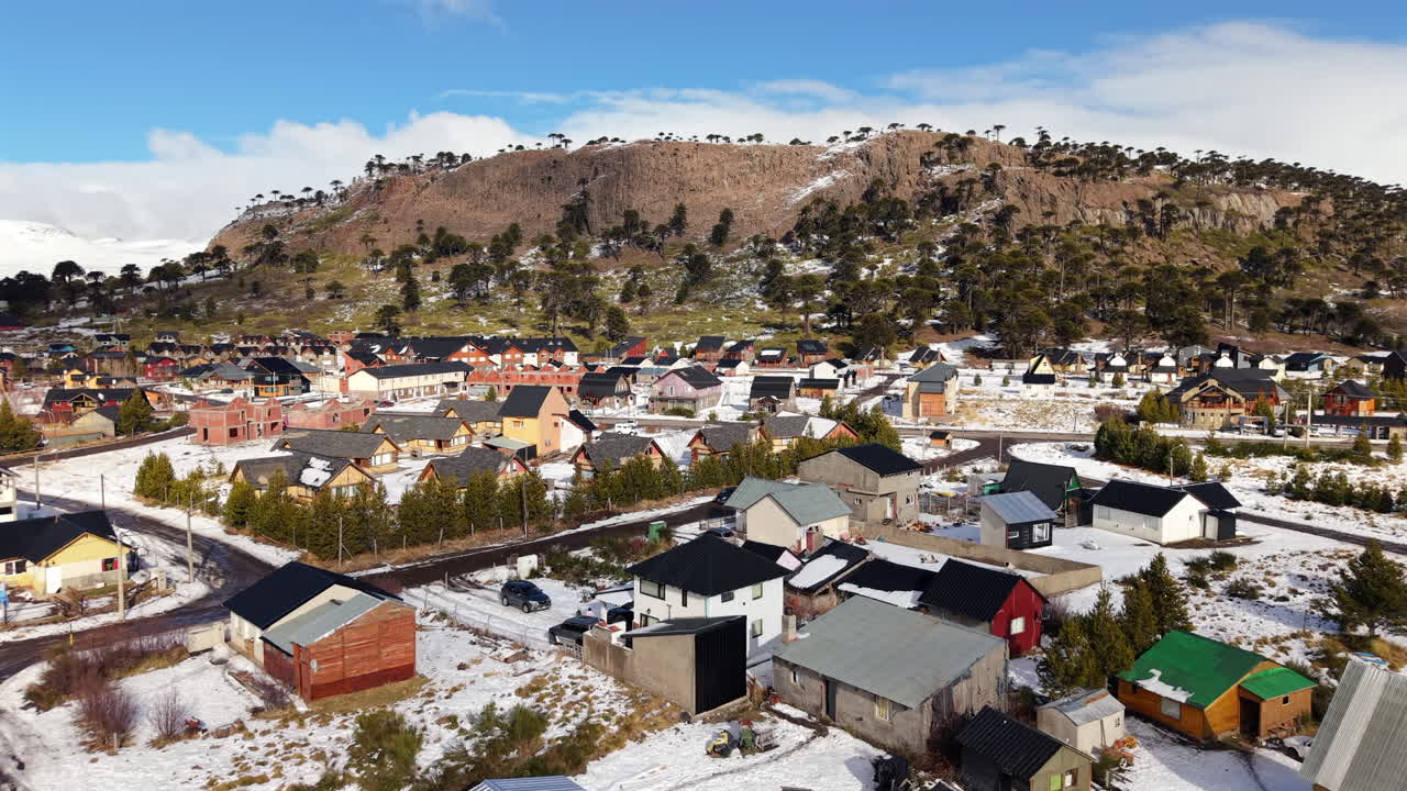 Aerial Flying Over Small Rural Town in Caviahue, Argentina, Covered in Winter Snow