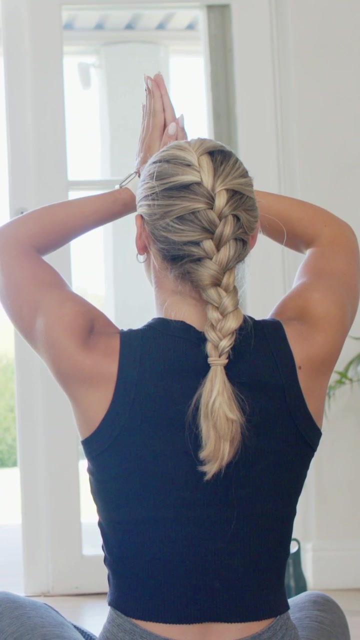 Vertical video: Raising woman performing breath stretches at home by doors in athletic wear